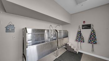 A room with a stainless steel tank and a sign that says